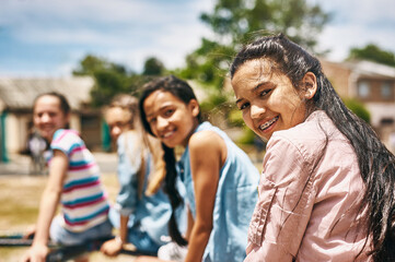 Children, friends and portrait at playground park for childhood development in middle school, students or bonding. Girls, face and outdoor playing or youth together as recreation, wellness or fun
