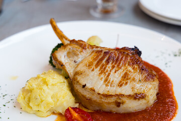 Grill pork fillet with bone and potato mash in the restaurant