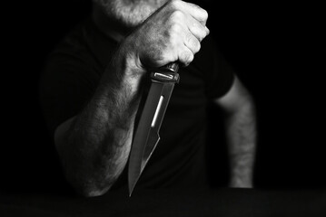 man wielding make expressively holding cutting metal blade black and white photo art expression