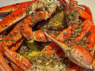 Steamed snow crab legs and claws drenched in garlic butter