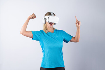Girl pointing or spinning basketball while using VR glasses. Caucasian woman flexing while wearing...