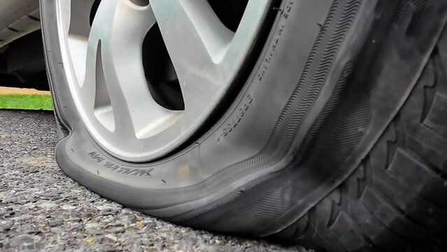 Flat Tire Of Mini Van CarOn Side Of  Road.