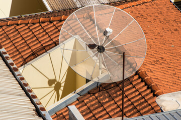 Satellite dish on the roof tile.Parabolic antenna, an antenna for catching domestic and foreign TV...