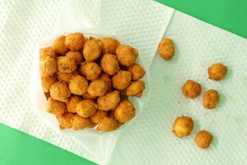 Malaysian delicious snack with a traditional legendary recipe featuring ground peanuts, spice powder, sesame seeds, and more. Homemade, fried, and served, found at your convenience store.