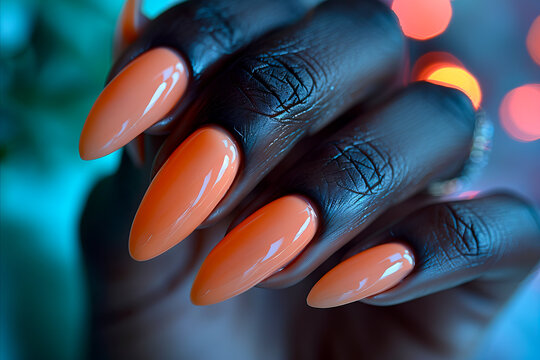 A woman with orange nails holding a nail polish.