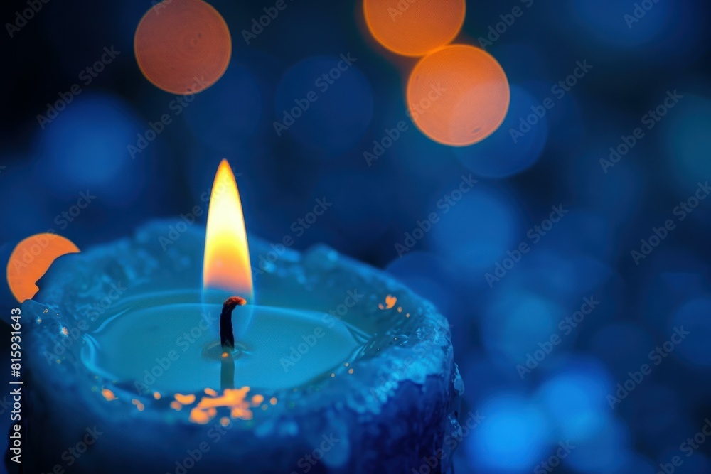 Poster close-up of a tranquil candle flame with a soft blue bokeh effect in the backdrop