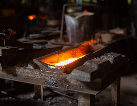 Mold with molten metal in the foundry workshop of metallurgical plant