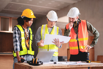 Engineer or architect team collaboration working in site discussing on blueprint building structure paperwork meeting for real estate project cooperation with partner and engineering equipment tools