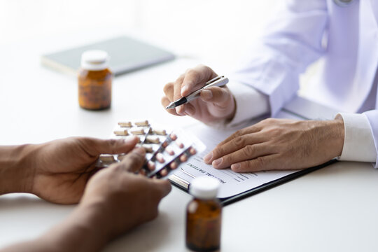 Specialized doctor is explaining taking medicine to a patient. Health and medicine consultation.