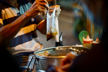 Traditional indonesian meatball street vendors preparing orders for the customer during the night