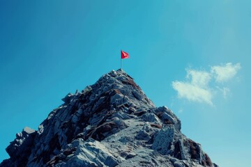 Naklejka premium Triumph at the Summit: Flag on Mountain Peak Symbolizing Achievement