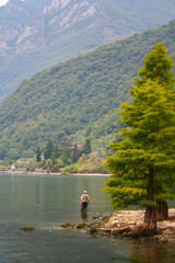 Person fishing in a beautiful lake in Italy..
