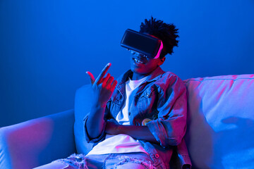 Young African American looking VR enjoy watching in scary funny fantastic 3D cartoon movie...