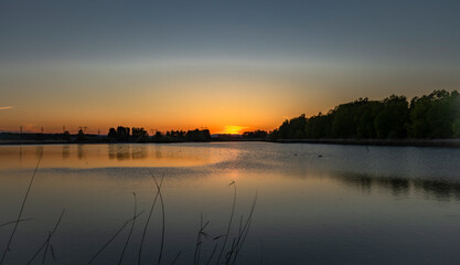 Obraz premium Bezdrev pond with spring color sunset from beach