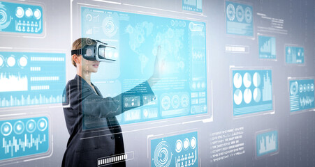 Skilled business woman pointing at financial data while wearing VR glasses. Professional project...
