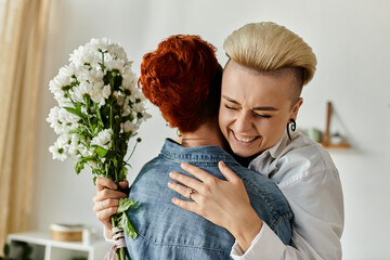 Two women with short hair embrace while holding flowers, celebrating love and companionship in an...