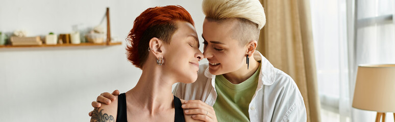 Two women with short hair share a heartfelt hug in their cozy living room, expressing love and...