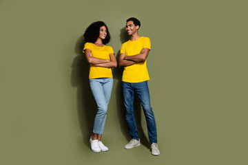 Fototapeta premium Full body portrait of two nice people folded arms look each other wear t-shirt isolated on khaki color background