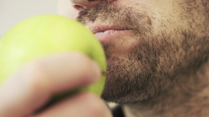 Man with green apple in his hand. Slow motion. Nutrition and healthy concept