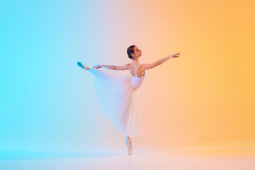 Elegant ballet dancer in white ensemble gracefully extends in neon light against blue-orange gradient background. Concept of art, movement, classical and modern fusion, beauty and fashion. Ad