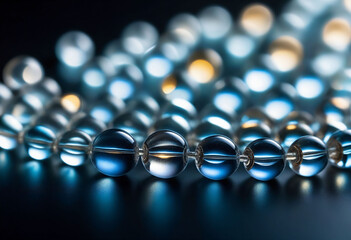 A close-up image of small, round, transparent beads with a shiny surface reflecting the light
