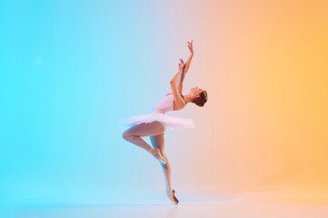 Obraz premium Young ballerina in white tutu dancing and leaning backwards in motion in neon light against blue-orange gradient background. Concept of art, movement, classical and modern fusion, beauty and fashion.
