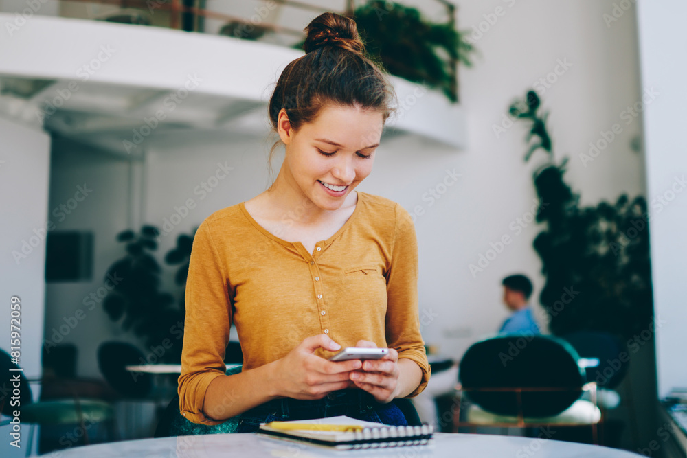 Aufkleber cheerful smiling female blogger searching information for own content in social networks while readi