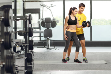 Fitness coach exercising with a young woman