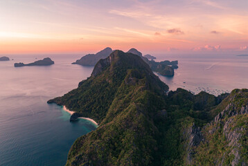 Fototapeta premium Aerial view of tropical islands at sunset in calm ocean. Palawan, Philippines.