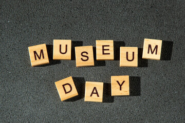 Museum day wooden letters text black background. 18 May