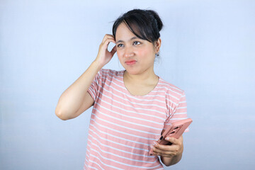 confuse expression of Asian woman holding smart phone on white background