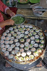 Zooming in on the delicious details of Bánh Khọt. This Vietnamese specialty from the south features crispy rice flour cups filled with savory goodness.