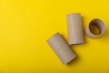 Empty toilet paper roll. Rolls of toilet paper on background. Paper tube of toilet paper. Place for text. Copy space. Flat lay. Eco-friendly reuse recycle