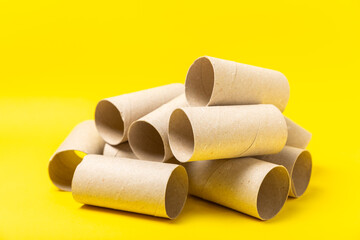 Empty toilet paper roll. Rolls of toilet paper on background. Paper tube of toilet paper. Place for text. Copy space. Flat lay. Eco-friendly reuse recycle