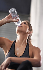 Woman, thirsty and gym with drinking water bottle for hydration with training for health or cardio....