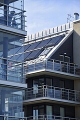 Collector system for heating water from the sun on the roof of a multi-storey modern building....