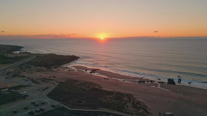 Serene sea evening sky in aerial view. Sunset illuminating scenic peaceful coast