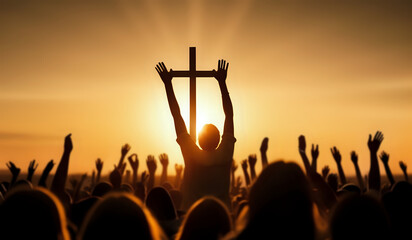 Lot of Christian worshipers raising hands up in the air for the cross in background in golden hour.