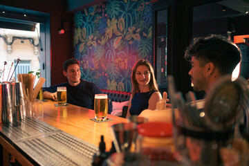 Group of people sitting at a bar