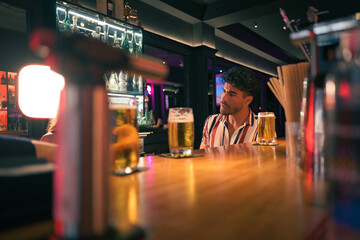 Man sitting at bar with beer