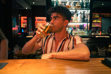 Man drinking beer at bar