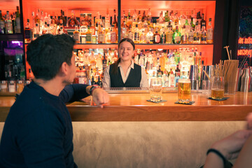 Smiling bartender serving drinks at cozy pub in the evening