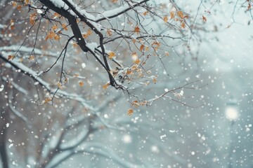 A serene winter scene with golden leaves against soft snowfall