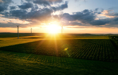 Windmill turbines generating green energy electric.Green energy helps reduce carbon emissions and...