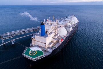 Aerial of Liquified Natural Gas LNG carrier moored to a small gas terminal. Fuel crisis. Sanctions