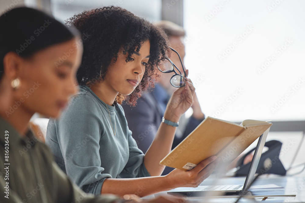 Poster Coworking, office and employee reading notes in call center for virtual technical support or feedback. Woman, learning and writing strategy for customer service, report and reminder in notebook