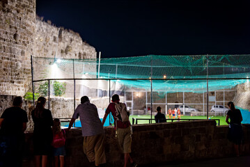Children play football on a small football field. © M-Production