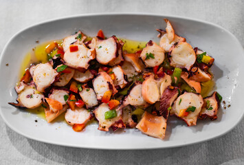 Octopus salad dressed with olive oil and vegetables.