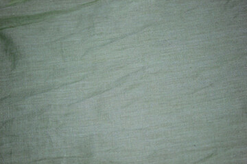 Obraz premium Close-up photo of stretch fabric. Green Textile Background Synthetic Fabric.