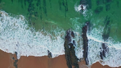Drone surf rolling beach in summer. Aerial view revealing sea turquoise waves